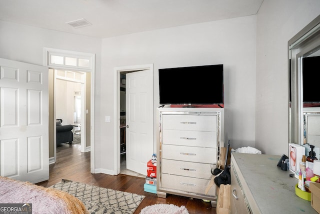 bedroom with dark hardwood / wood-style floors