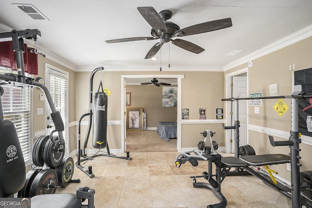 workout area with light tile patterned flooring, ceiling fan, and crown molding