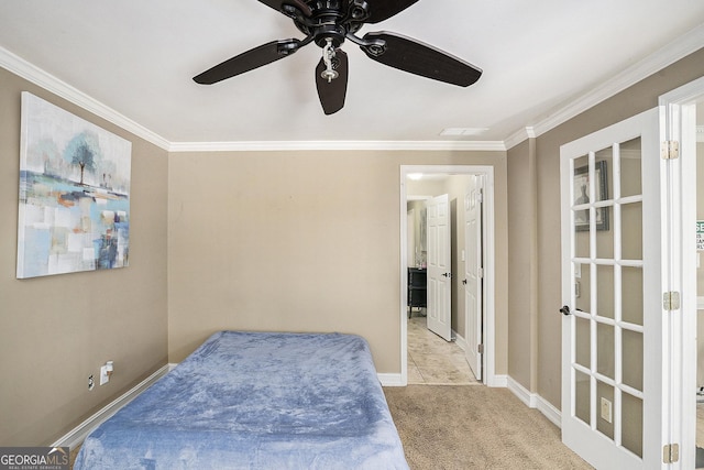 carpeted bedroom featuring ceiling fan and crown molding