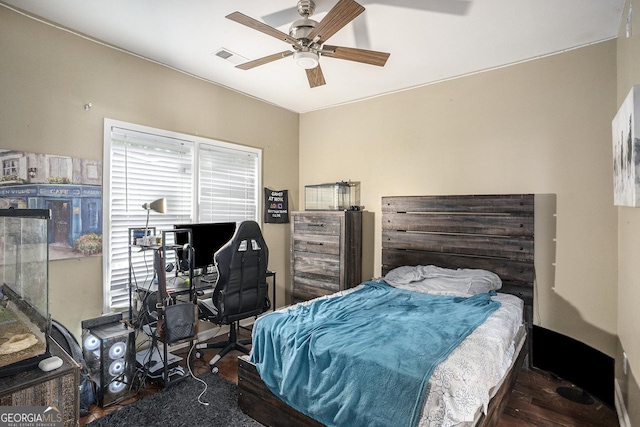 bedroom featuring dark hardwood / wood-style flooring and ceiling fan