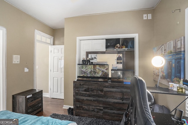 bedroom featuring a closet and dark hardwood / wood-style floors