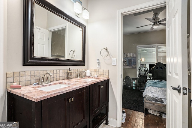 bathroom with ceiling fan, hardwood / wood-style floors, backsplash, and vanity