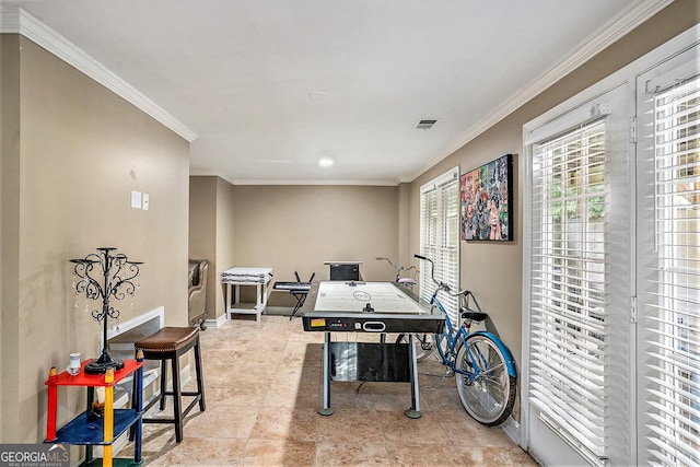 rec room with ornamental molding and light tile patterned floors