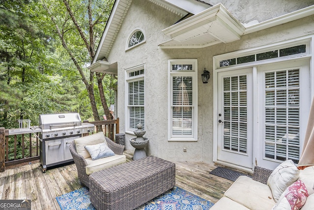 wooden terrace with a grill