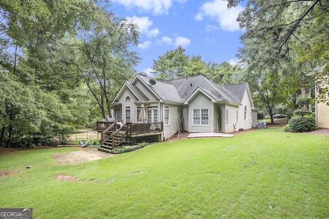 rear view of property featuring a patio, a wooden deck, central air condition unit, and a lawn