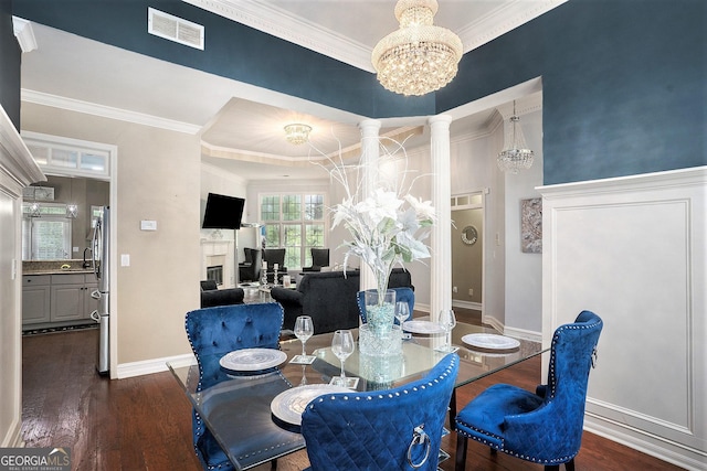 dining area featuring an inviting chandelier, crown molding, and dark hardwood / wood-style floors