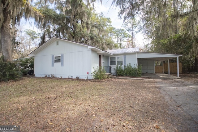 single story home featuring a carport