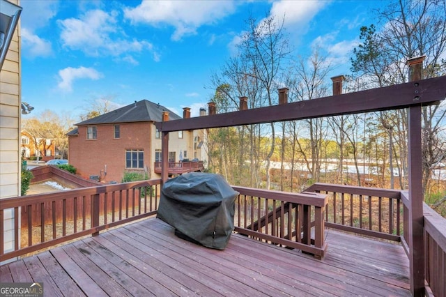 wooden deck with a grill