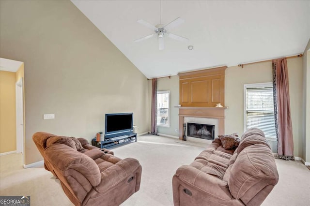 living room with a fireplace, high vaulted ceiling, ceiling fan, and light carpet