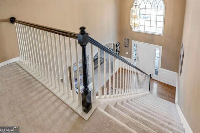 staircase featuring a chandelier