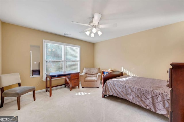 bedroom with ceiling fan and light carpet