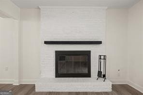 details featuring a large fireplace and hardwood / wood-style floors