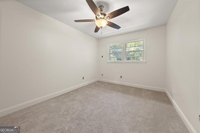 unfurnished bedroom with ceiling fan, a closet, and light colored carpet