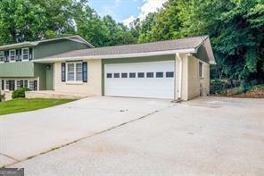 split level home with a garage and concrete driveway