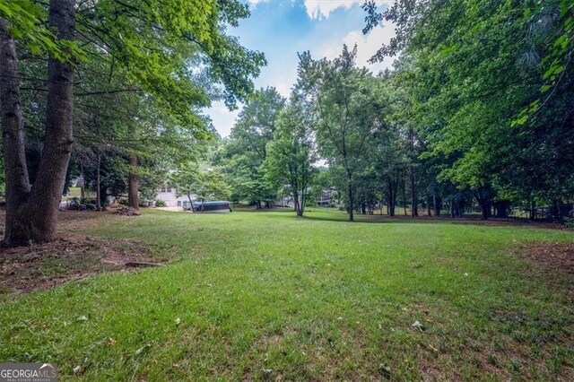 view of pool featuring a yard and a patio