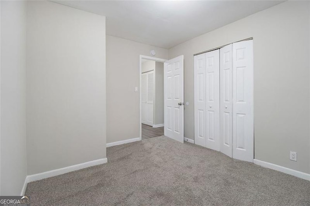 unfurnished bedroom with a closet and carpet