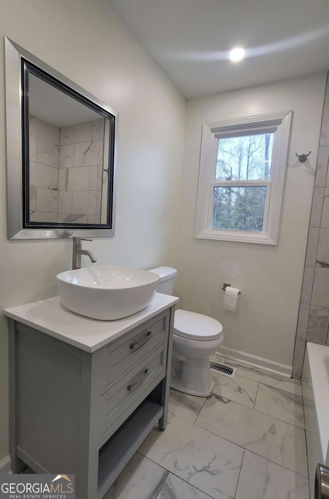 bathroom with toilet and vanity