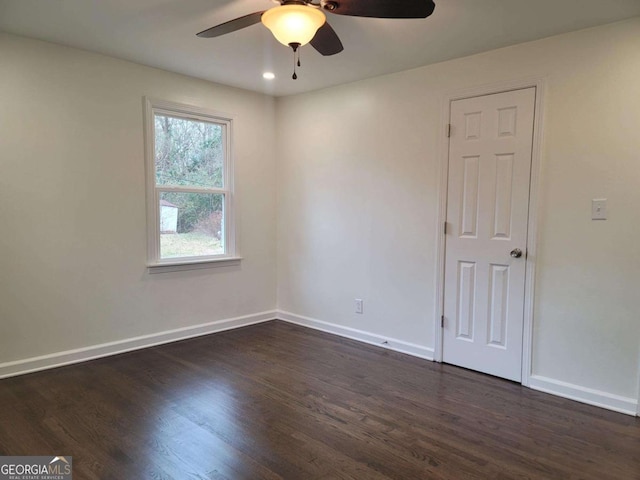 unfurnished room with ceiling fan and dark hardwood / wood-style floors