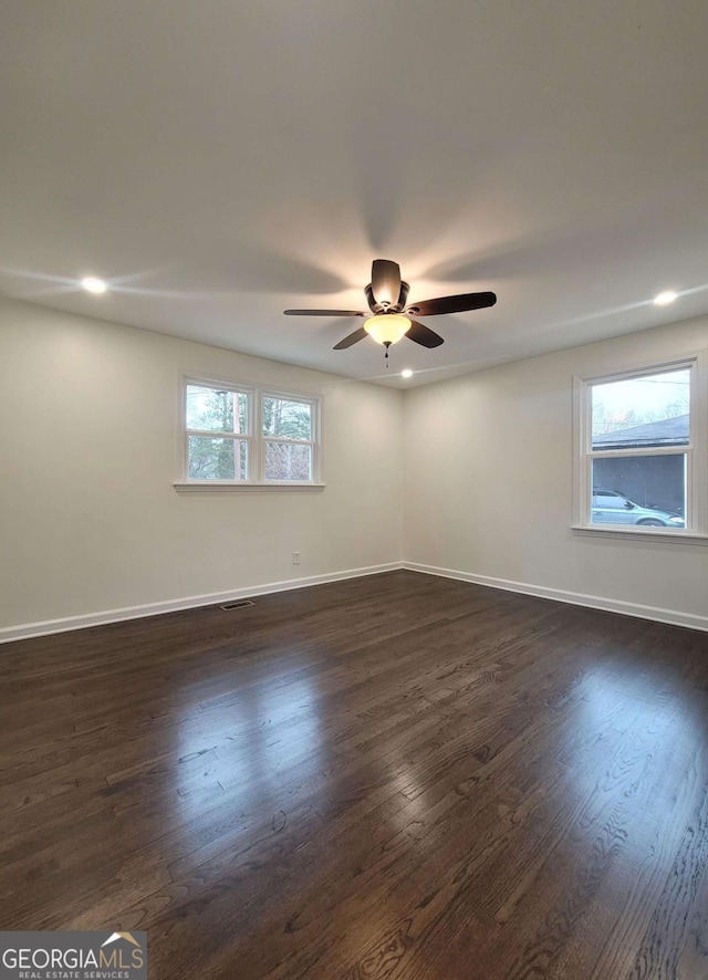 spare room with ceiling fan and dark hardwood / wood-style floors