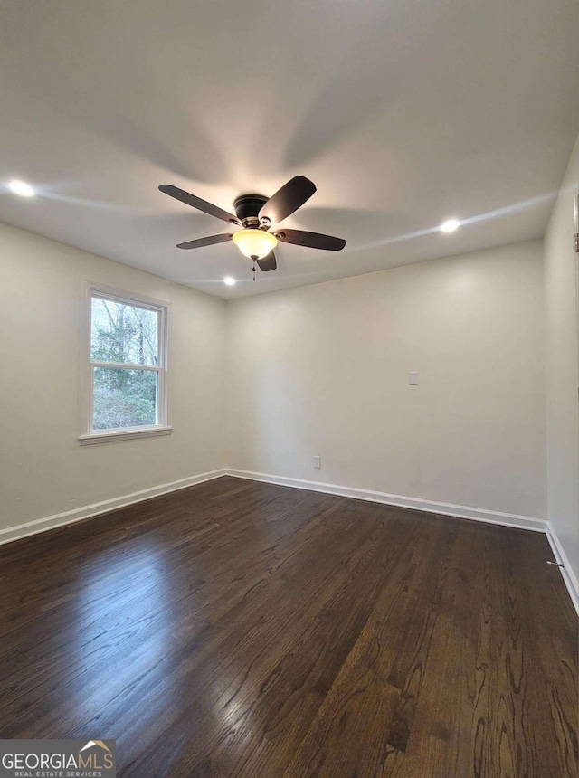 empty room with ceiling fan and dark hardwood / wood-style floors