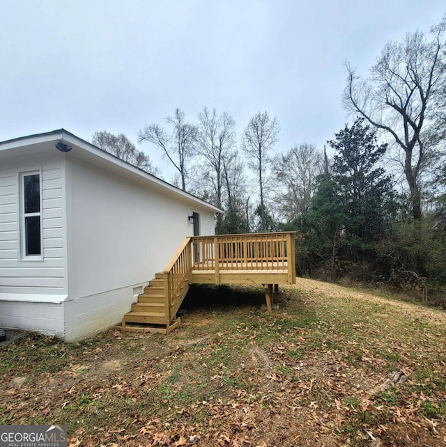 view of side of property with a wooden deck