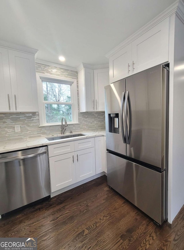 kitchen featuring sink, white cabinets, appliances with stainless steel finishes, and dark hardwood / wood-style floors