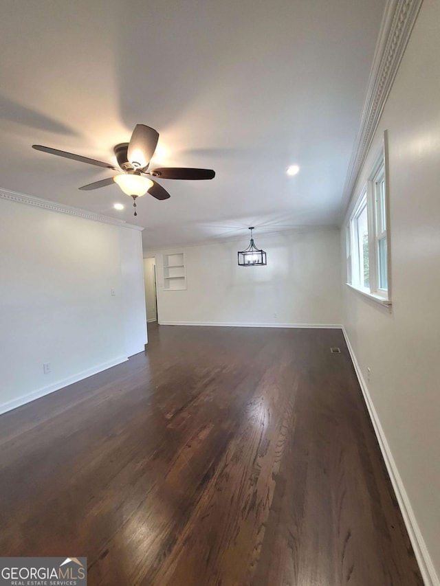 unfurnished room with ceiling fan, dark hardwood / wood-style flooring, and ornamental molding