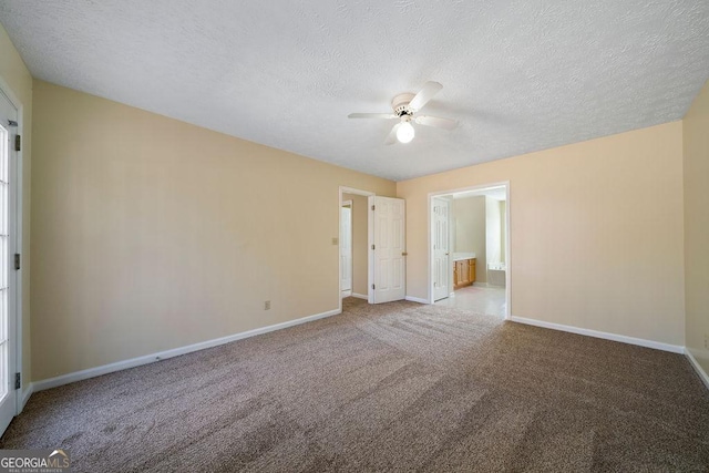 spare room featuring ceiling fan, carpet, and a textured ceiling