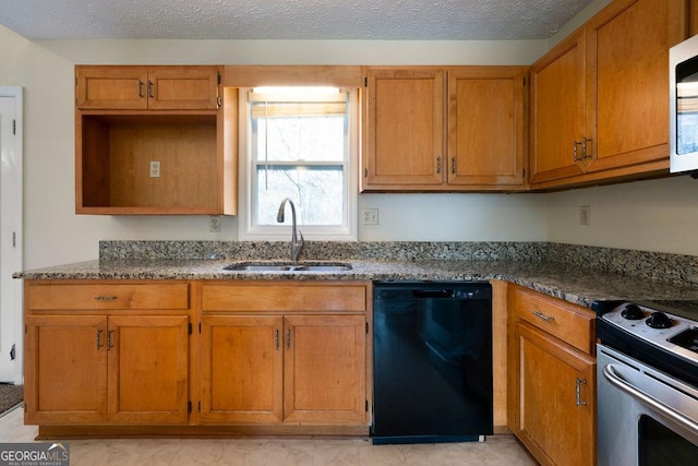 kitchen featuring stainless steel appliances, dark stone countertops, and sink