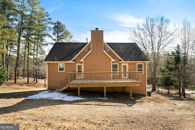 back of property with a wooden deck