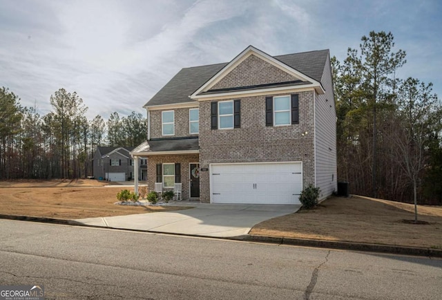 view of front of property with a garage, covered porch, and central AC unit