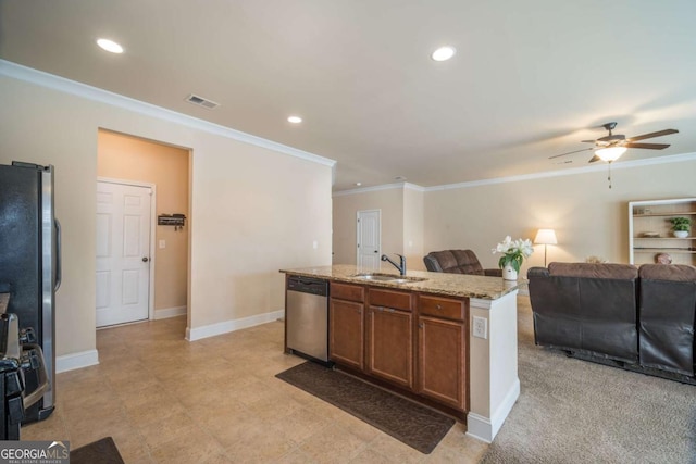 kitchen featuring a center island with sink, ceiling fan, appliances with stainless steel finishes, light stone counters, and sink