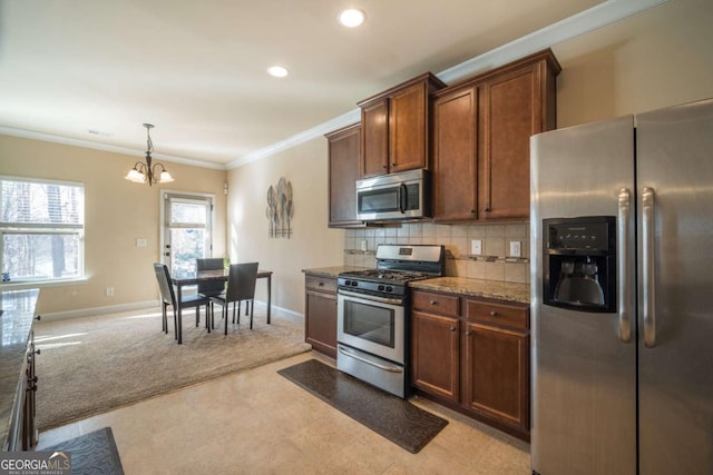 kitchen with light carpet, an inviting chandelier, stainless steel appliances, decorative backsplash, and stone counters