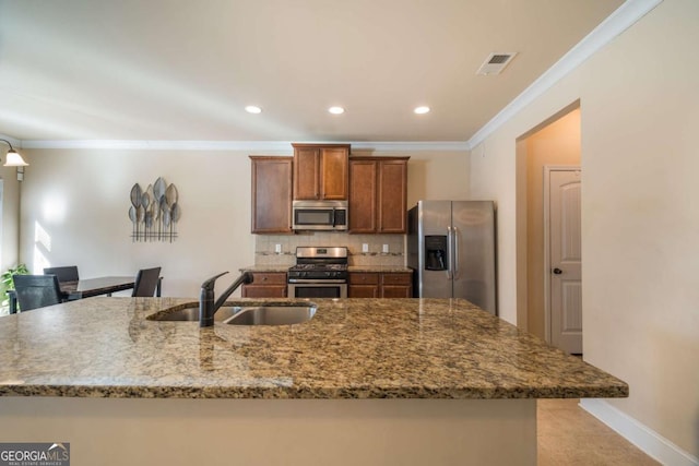 kitchen featuring appliances with stainless steel finishes, backsplash, ornamental molding, light stone counters, and sink