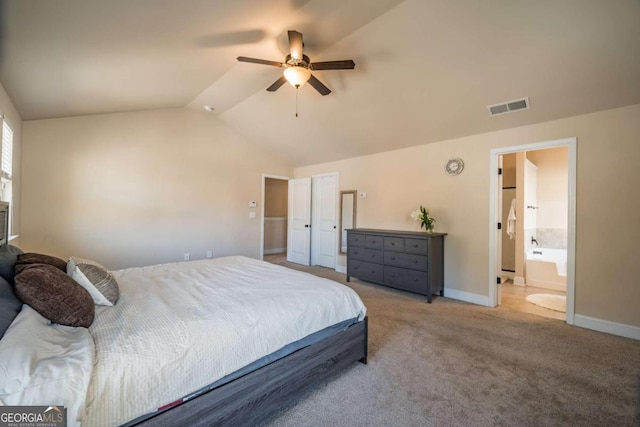 carpeted bedroom featuring ceiling fan, vaulted ceiling, and ensuite bathroom