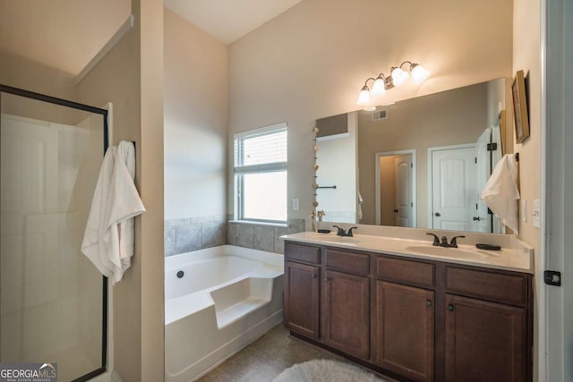 bathroom with vanity, tile patterned floors, and plus walk in shower