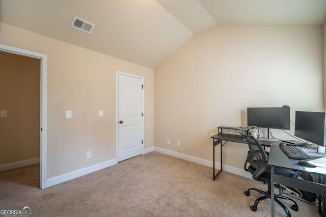 office featuring light carpet and vaulted ceiling