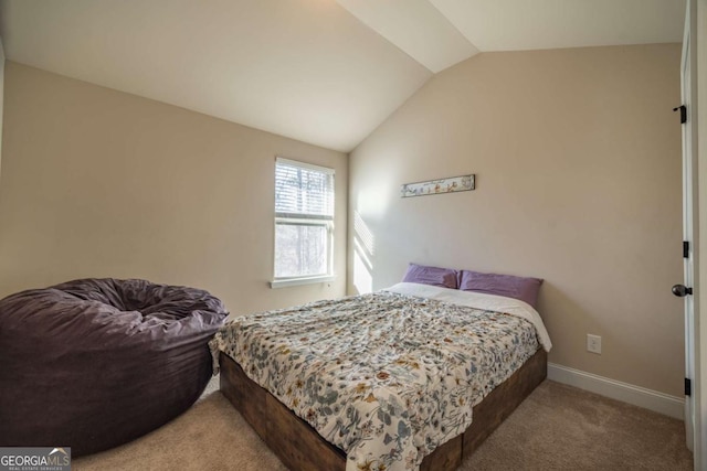 bedroom featuring carpet floors and lofted ceiling