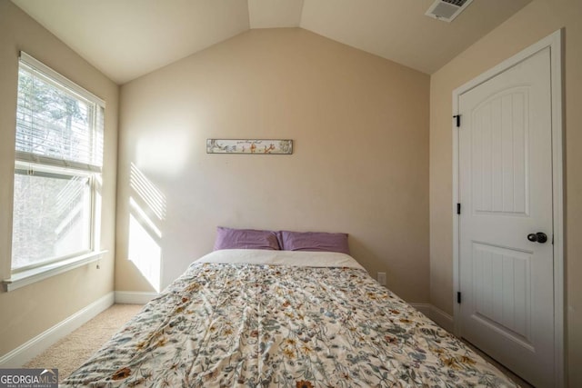 carpeted bedroom featuring vaulted ceiling