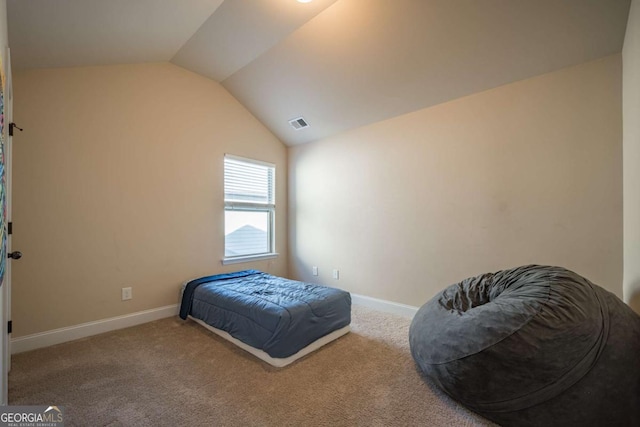 carpeted bedroom with vaulted ceiling