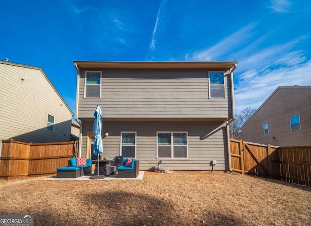 back of house featuring a patio area and an outdoor living space