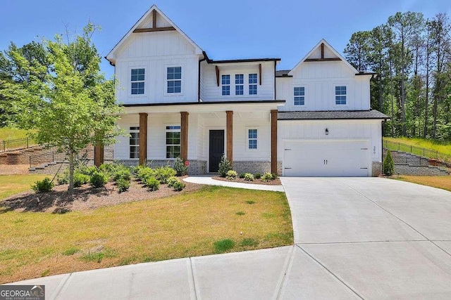 modern farmhouse with a porch, a front yard, and a garage