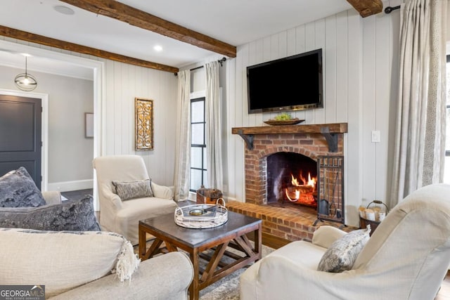 living room featuring a fireplace, wooden walls, and beamed ceiling