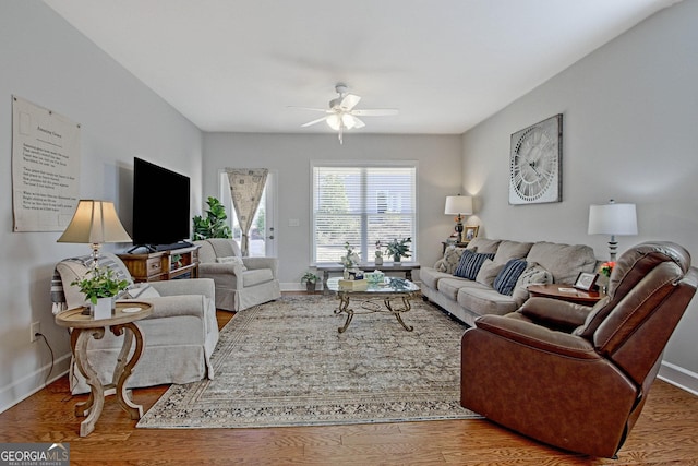 living room featuring ceiling fan and hardwood / wood-style floors