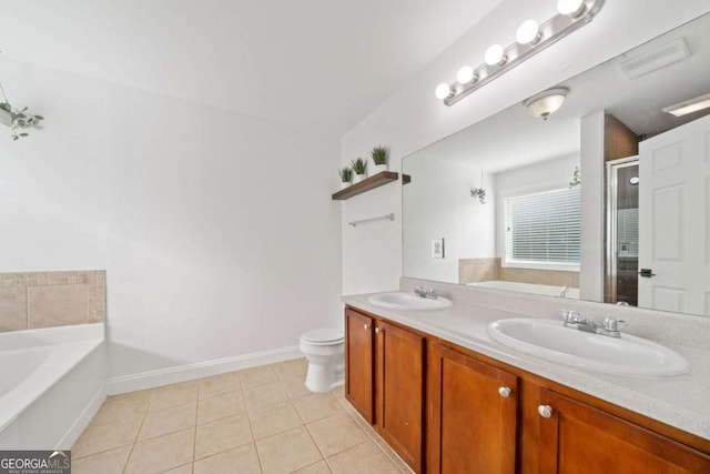 bathroom featuring toilet, tile patterned flooring, a bath, and vanity