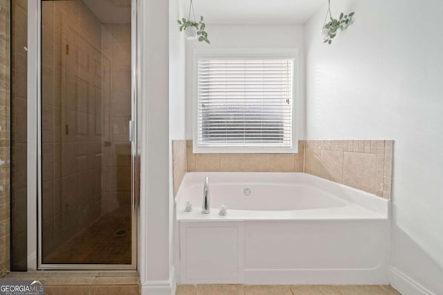 bathroom featuring plus walk in shower, tile patterned floors, and a healthy amount of sunlight