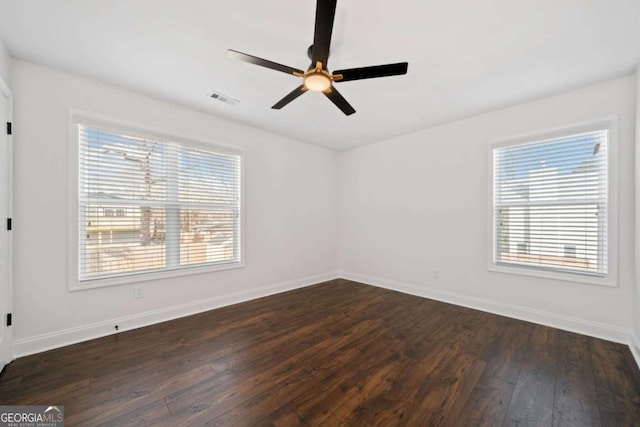 unfurnished room featuring dark hardwood / wood-style flooring, ceiling fan, and plenty of natural light