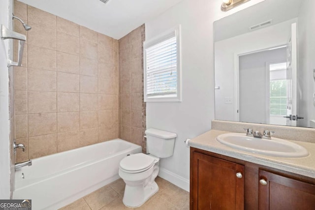 full bathroom featuring toilet, vanity, tile patterned floors, and tiled shower / bath