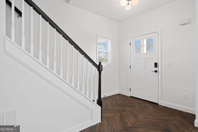 foyer featuring dark parquet flooring