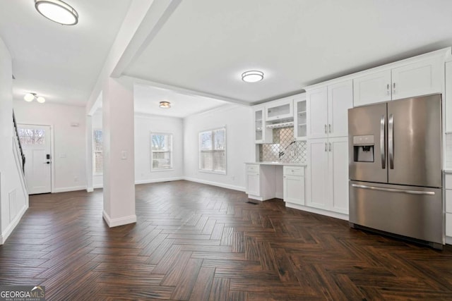 kitchen featuring dark parquet flooring, white cabinetry, tasteful backsplash, and stainless steel fridge with ice dispenser